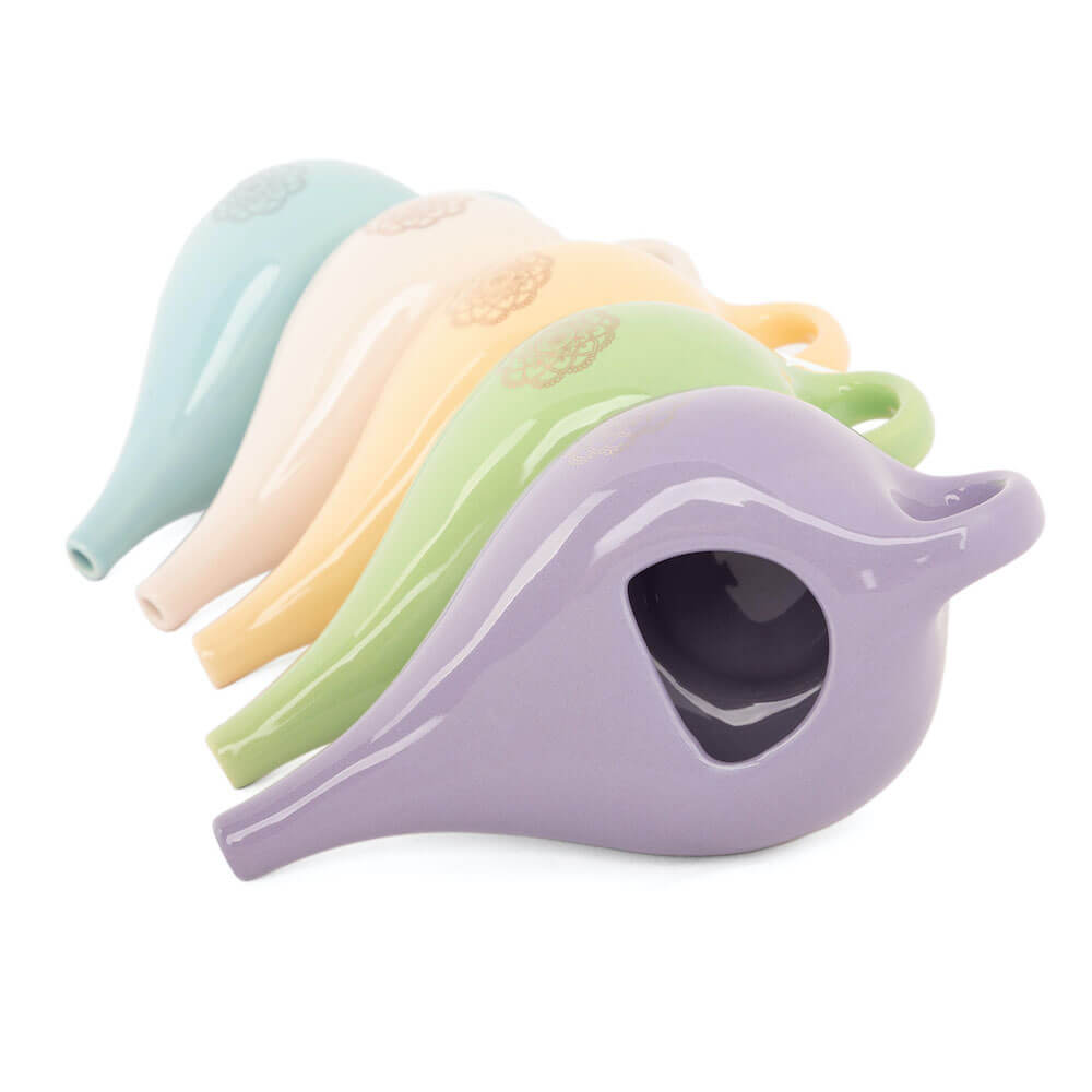 Experience the beauty and functionality of this cute glazed ceramic Neti pot, adorned with a mandala design. Available at Vayu Living.