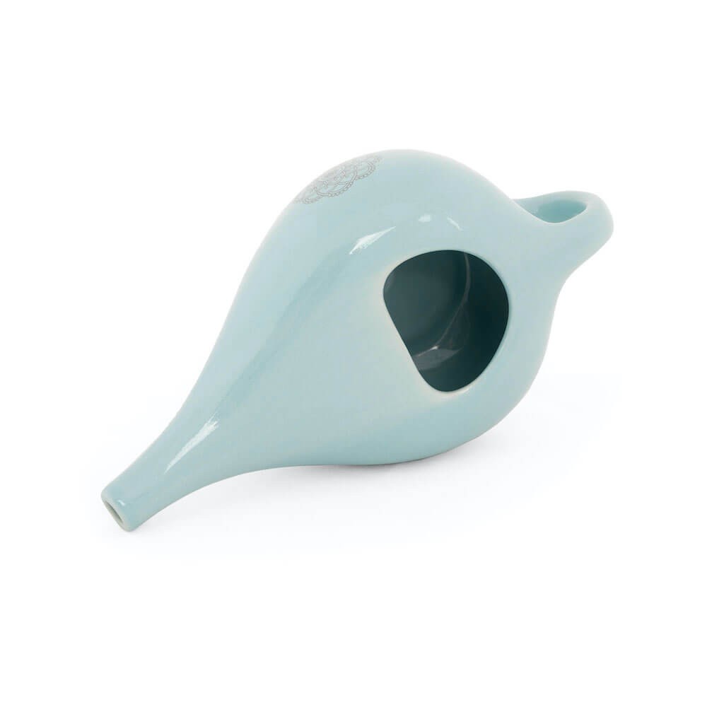 Experience the beauty and functionality of this cute glazed ceramic Neti pot, adorned with a mandala design. Available at Vayu Living.