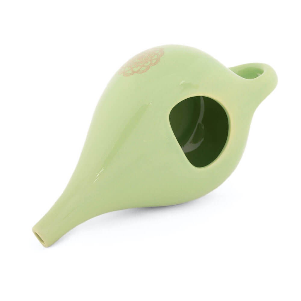 Experience the beauty and functionality of this cute glazed ceramic Neti pot, adorned with a mandala design. Available at Vayu Living.